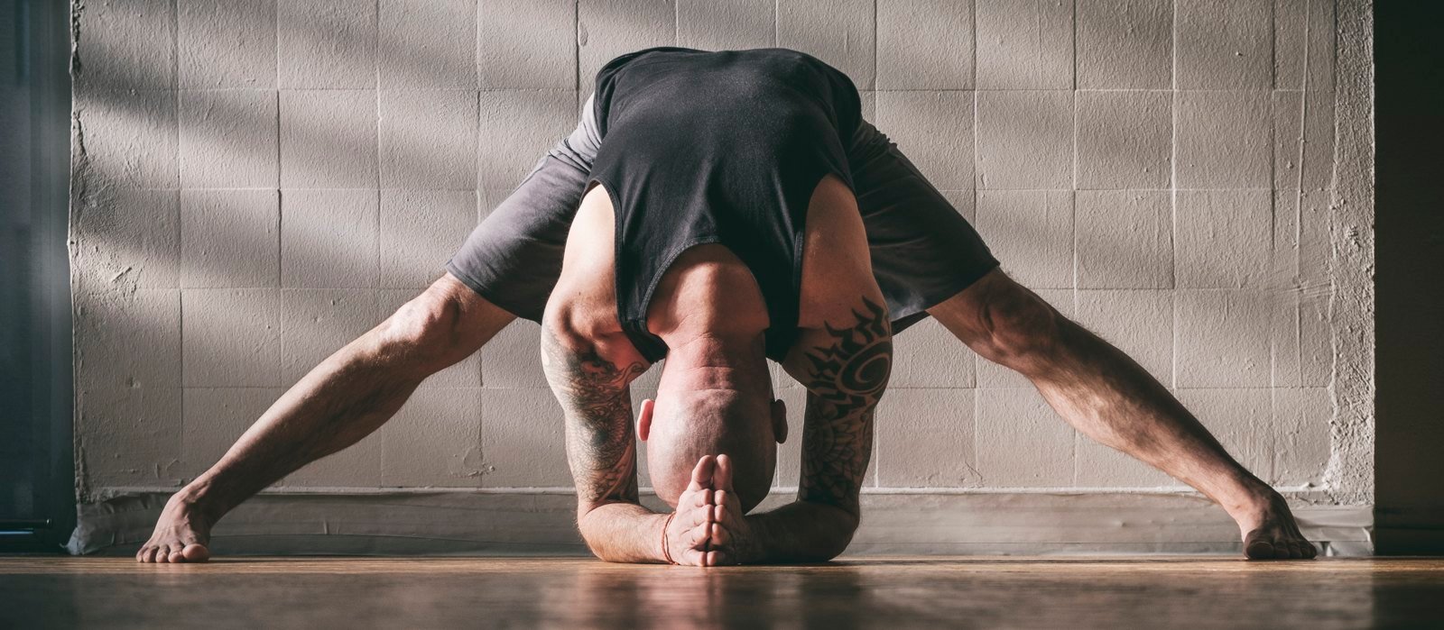 Andyji in a wide Prasarita Padottanasana